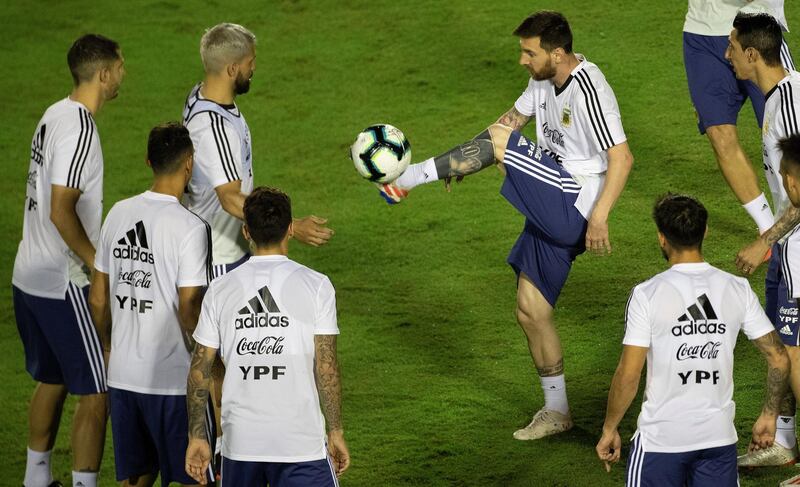 Messi controls the ball as his teammates look on. EPA