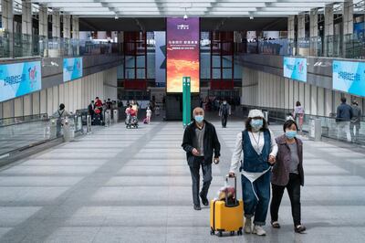 Travelers exit Beijing Capital International Airport in Beijing, China, on Saturday, May 1, 2021. Tickets for everything from domestic flights to theme parks are rapidly selling out in China ahead of its Labor Day holiday as the nation’s recovery gathers pace. Photographer: Yan Cong/Bloomberg