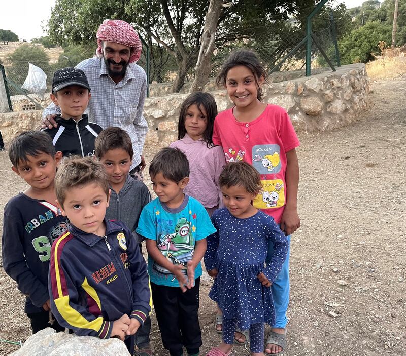 Mr Al Hadidi with his seven children and his nephew (wearing a baseball cap).