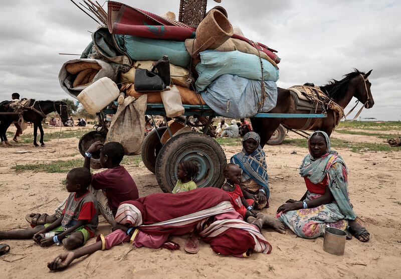 Sudanese family sit beside their belongings while waiting to be registered by the UN Refugee Agency after crossing the border into Adre, Chad. All photos: Reuters