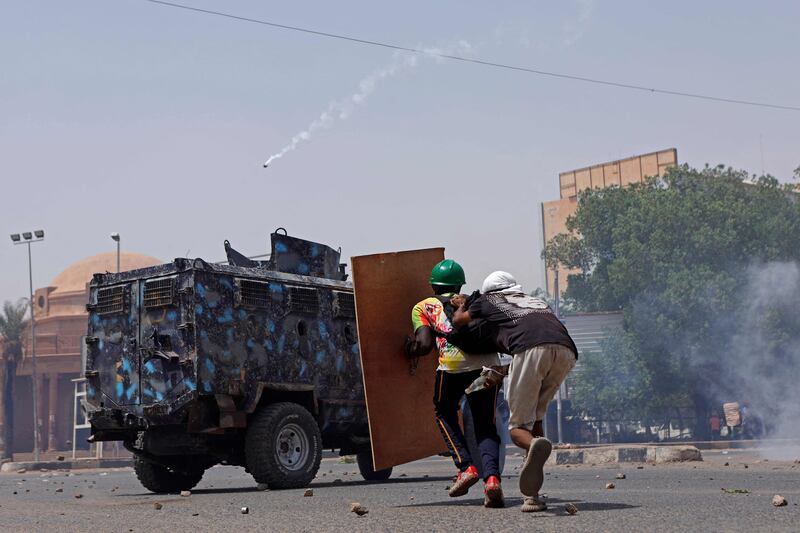 Protesters advance towards a security forces armoured personnel carrier. AFP