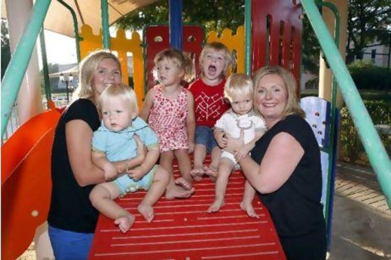 Kirsten Fairfield (left) and her children, Aidan and Jessica, enjoy playground time with Paula Harrington and her kids, Samuel and William.