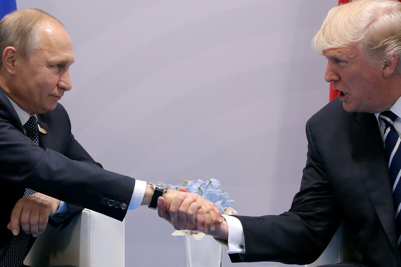 FILE PHOTO - U.S. President Donald Trump shakes hands with Russian President Vladimir Putin during the their bilateral meeting at the G20 summit in Hamburg, Germany July 7, 2017. REUTERS/Carlos Barria/File Photo