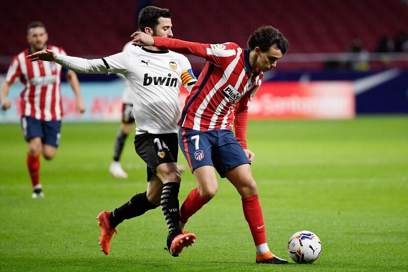 Atletico Madrid's Joao Felix vies with Valencia's Jose Luis Gaya Pena. AFP