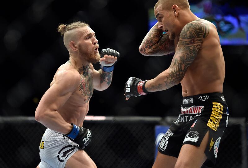 LAS VEGAS, NV - SEPTEMBER 27:  (L-R) Conor McGregor of Ireland punches Dustin Poirier in their featherweight bout during the UFC 178 event on September 27, 2014 in Las Vegas, Nevada. (Photo by Jeff Bottari/Zuffa LLC/Zuffa LLC via Getty Images)