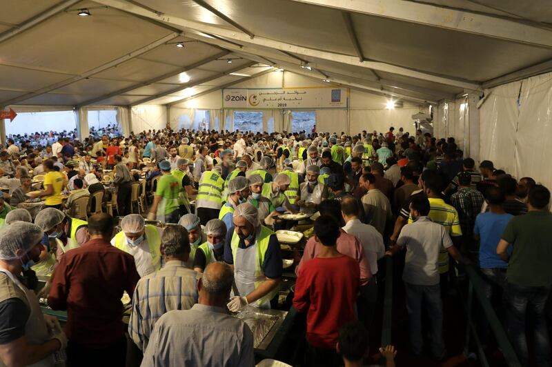 Volunteer of the Jordanian organisation Tkiyet Um Ali serve food at a Meydet Ramadan Iftar, in Amman. EPA