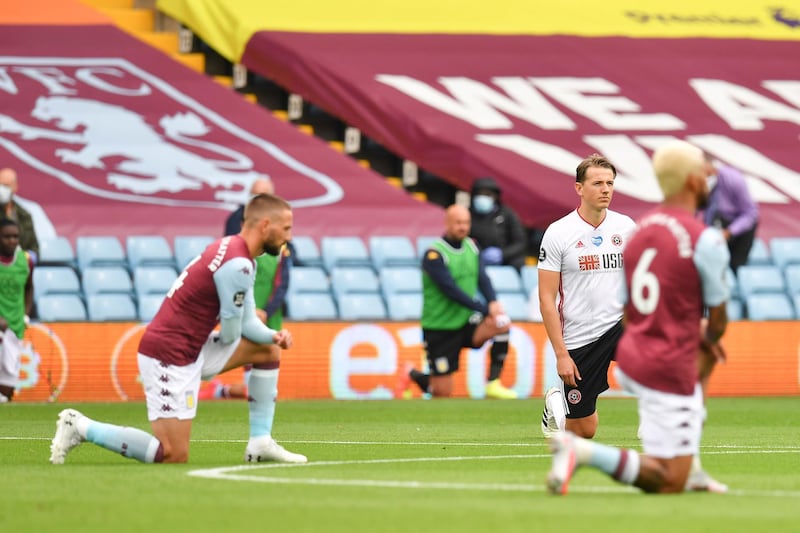 Players of Aston Villa and Sheffield United take a knee ahead of the game at Villa Park. EPA