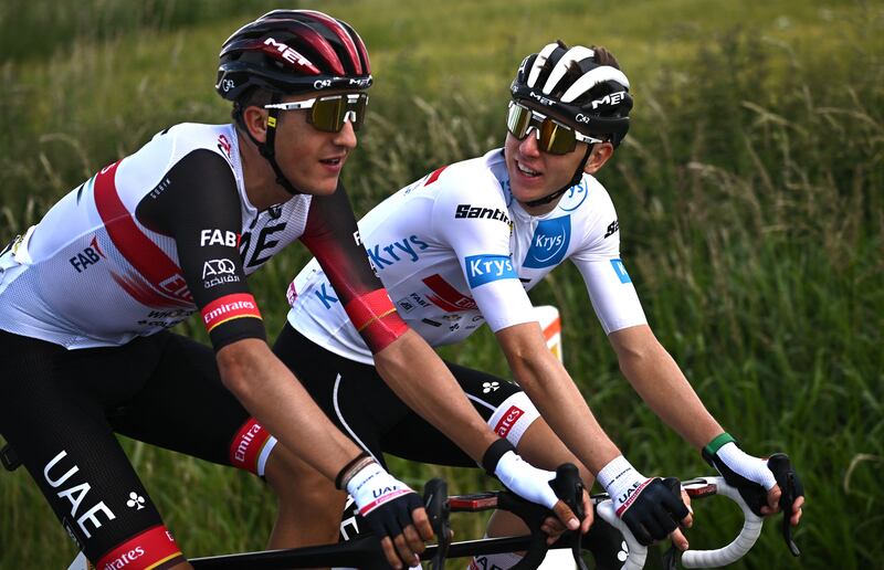 UAE Team Emirates' rider Tadej Pogacar speaks with teammate Marc Soler. AFP