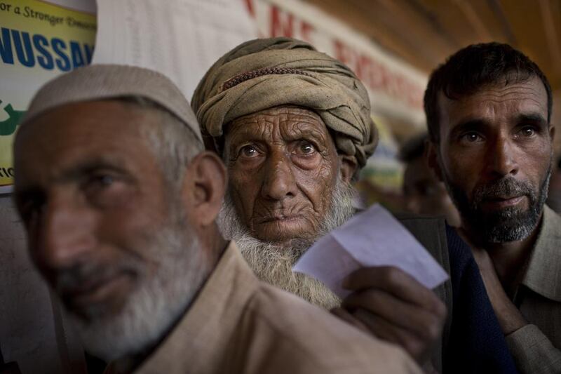 A Kashmiri man belonging to the nomadic Gujjar tribe, center, lines-up to cast his vote during the Indian parliamentary elections at a polling station in Wasun. Bernat Armangue / AP Photo