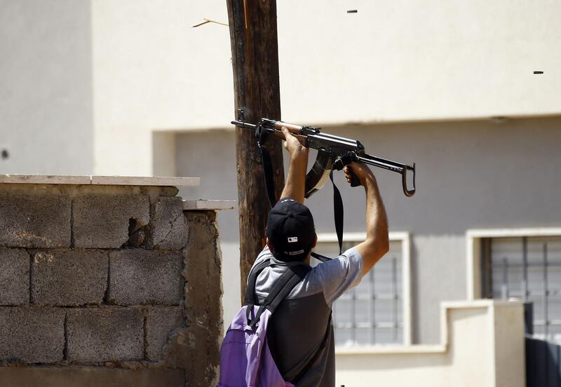 A fighter loyal to the internationally recognised Libyan Government of National Accord (GNA) fires his gun during clashes with forces loyal to strongman Khalifa Haftar in the capital Tripoli's suburb of Ain Zara.  AFP
