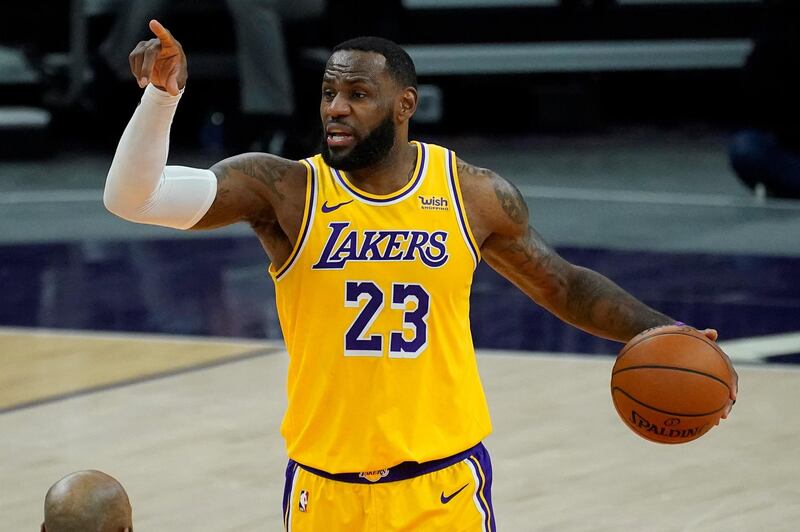 LeBron James calls a play for the Los Angeles Lakers against the Phoenix Suns during the first half of a preseason game. AP Photo