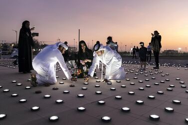 Volunteers help set up the light installation which celebrates a five-month journey spanning five continents for the Zayed Sustainability Prize's Guiding Light scheme. Reem Mohammed/The National