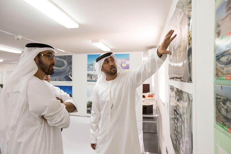 AL AIN, EASTERN REGION OF ABU DHABI, UNITED ARAB EMIRATES - May 08, 2013: HH General Sheikh Mohamed bin Zayed Al Nahyan Crown Prince of Abu Dhabi Deputy Supreme Commander of the UAE Armed Forces (L), and HE Mohamed Mubarak Al Mazrouei Under-Secretary of the Crown Prince Court of Abu Dhabi (R), look at illustrations of the new Hazza Bin Zayed Stadium, which will serve as the new home ground of Al Ain Football Club. .( Ryan Carter / Crown Prince Court - Abu Dhabi ).---