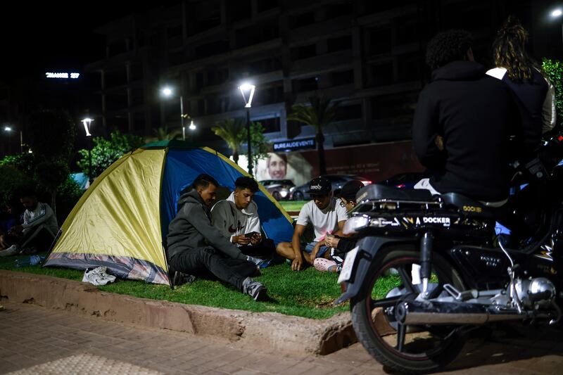 People sit in a tent on Mohammed VI Avenue in Marrakesh. EPA