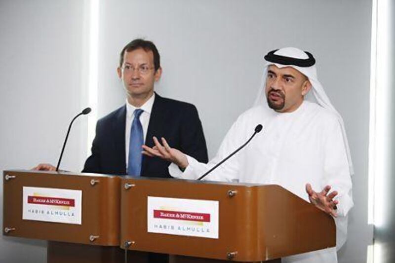 Borys Dackiw, left, the managing partner of Baker & McKenzie in the Gulf region and Habib Al Mulla, announce the merger of the law firms in Dubai yesterday. Sarah Dea / The National