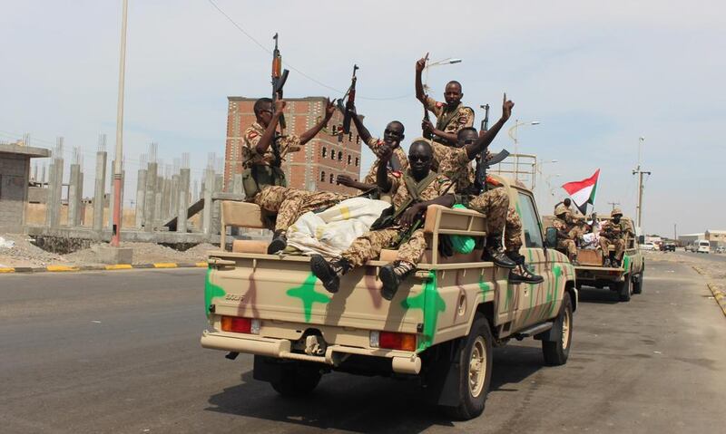 Sudanese soldiers wave after their arrival in  Aden on November 9, 2015, to take part in coalition operations in Yemen. Wael Qubady / AP Photo