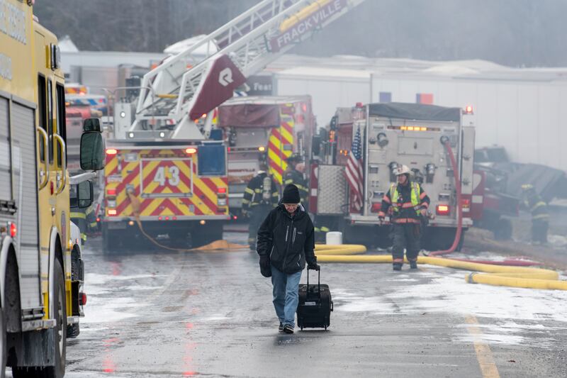 Dane Groszek of Middletown, New York, makes his way off the Interstate 81 motorway after his car was destroyed in a multi-vehicle crash. Mr Groszek was on his way home after visiting family in Daytona, Florida. Republican-Herald / AP