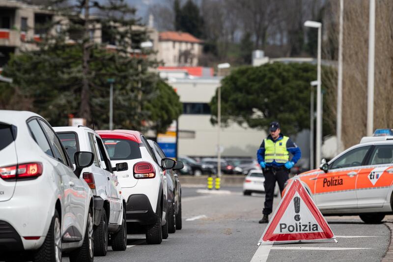 The Ticino cantonal police checks cars along the Italian-Swiss border after the Lombardy region was declared a red zone in Stabio, Switzerland.  EPA