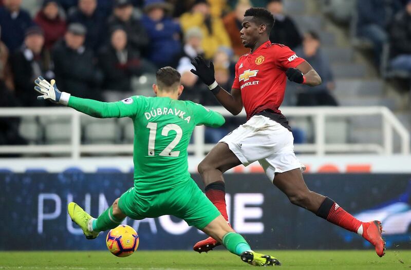 Manchester United's Paul Pogba, right, dribbles past Newcastle United goalkeeper Martin Dubravka but misses an open goal PA via AP