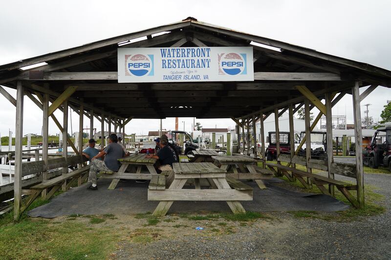 Watermen wait out foul weather under shelter. 