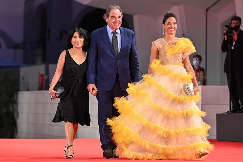 US director Oliver Stone, his wife Sun-jung Jung, left, and guest arrive to attend the Kineo Prize Ceremony on the fourth day of the 77th Venice Film Festival. AFP