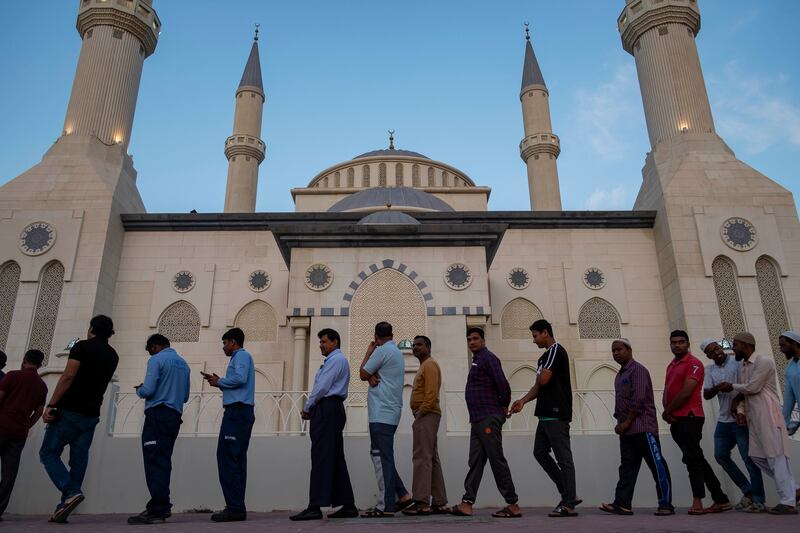 Worshippers queue for iftar at Al Farooq Omar bin Al Khattab Mosque in Dubai. Antonie Robertson / The National