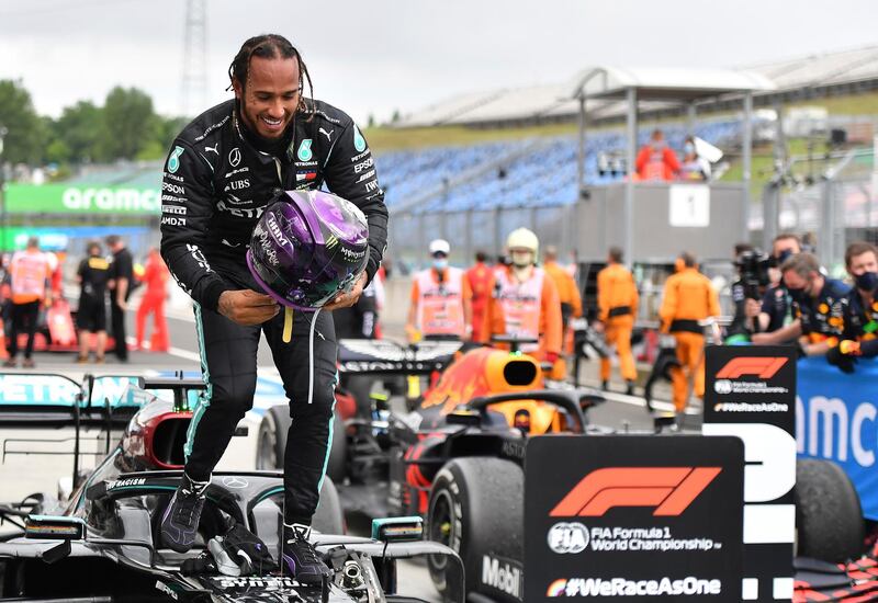 Mercedes driver Lewis Hamilton of Britain leaves his car after winning the Hungarian Formula One Grand Prix at the Hungaroring racetrack in Mogyorod, Hungary, Sunday, July 19, 2020. (Joe Klamar/Pool via AP)