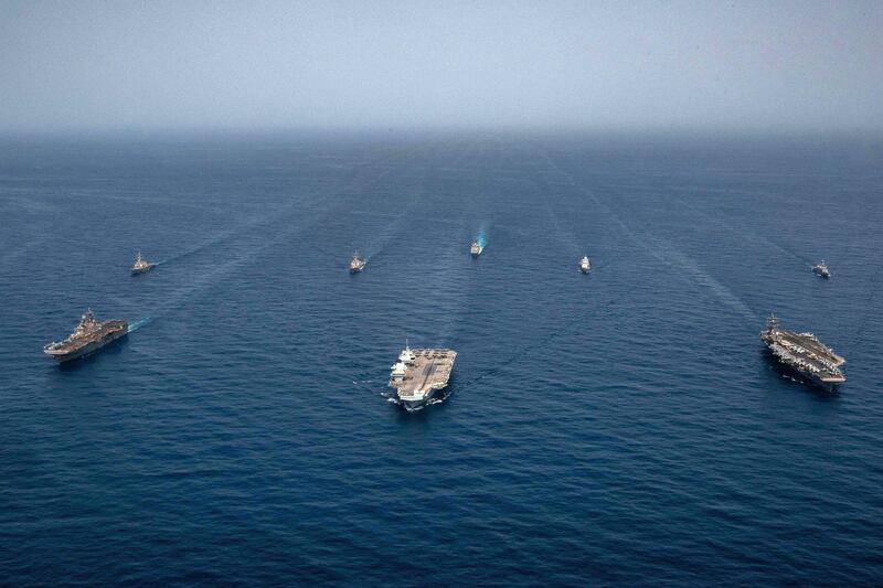 Ships of the UK Carrier Strike Group, USS Ronald Reagan Carrier Strike Group, and Iwo Jima Amphibious Ready Group pictured operating in formation in the Gulf of Aden on July 12.  (Gray Gibson/US Central Command/AFP).