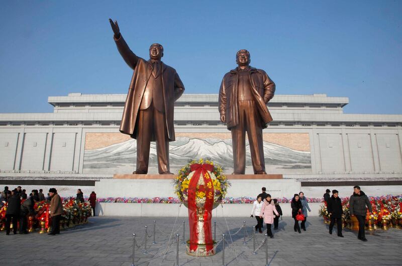 People visit the statues of former North Korean leaders Kim Il Sung, left, and Kim Jong Il, right, on Mansu Hill. (AP Photo/Jon Chol Jin)