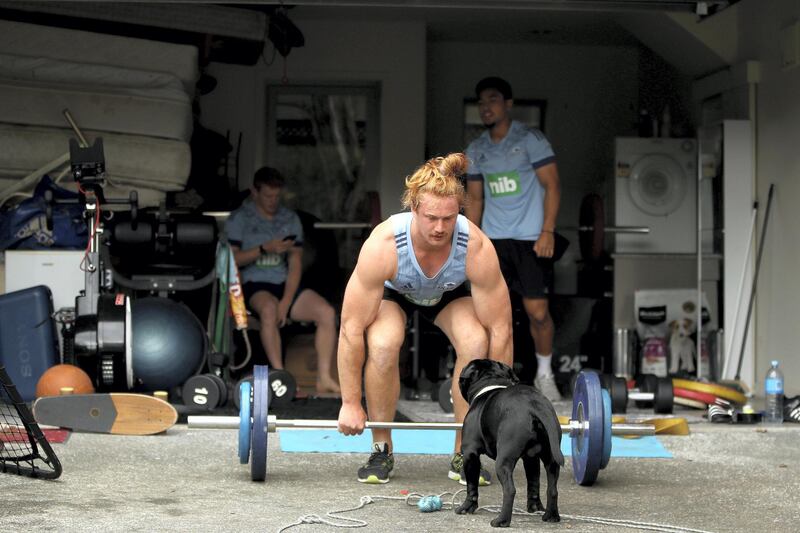 AUCKLAND, NEW ZEALAND - MARCH 27: Flatmates Stephen Perofeta, Finlay Christie and Tom Robinson of the Blues rugby team pictured during a weights session in their garage on March 27, 2020 in Auckland, New Zealand. The 2020 Super Rugby season was suspended on 14 March 2020 due to the ongoing COVID-19 pandemic and travel restrictions put in place which banned international travel. New Zealand is now in lockdown, with citizens required to remain at home as much as possible. All non-essential businesses are closed, including bars, restaurants, cinemas and playgrounds. Schools are closed and all indoor and outdoor events are banned. Essential services remain open, including supermarkets and pharmacies. New Zealand currently has 283 confirmed cases of COVID-19. (Photo by Phil Walter/Getty Images)