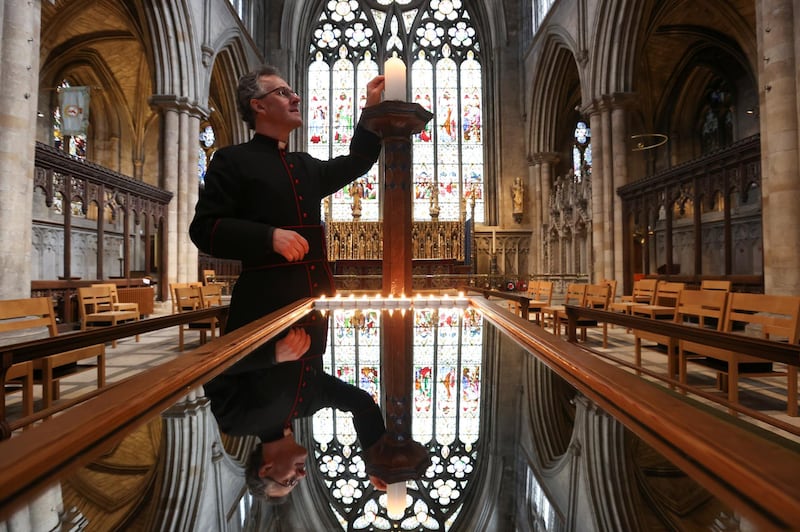 The Dean of Ripon, The Very Reverend John Dobson lights a candle of remembrance in Ripon. Reuters