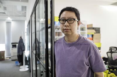 Alex Zhou, founder and chief executive officer of Nice, poses for a photograph at the office of the online sneaker trading platform in Beijing, China, on Wednesday, Sept. 25, 2019. Across China, more than 10 million monthly active users frequent online-resale apps for sneakers, such as Poizon, Nice and DoNew, according to Chinese data-mining company QuestMobile. While many products suffer from the effects of the trade war, pairs of collectible sneakers are flying off the shelves, and that's attracting the attention of U.S. sneaker exchanges like StockX and GOAT. Photographer: Qilai Shen/Bloomberg