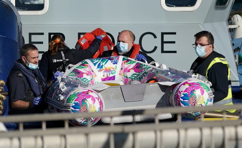 Border Force officers carry a small boat. A number of incidents involving small boats have been reported in the Channel this month. PA