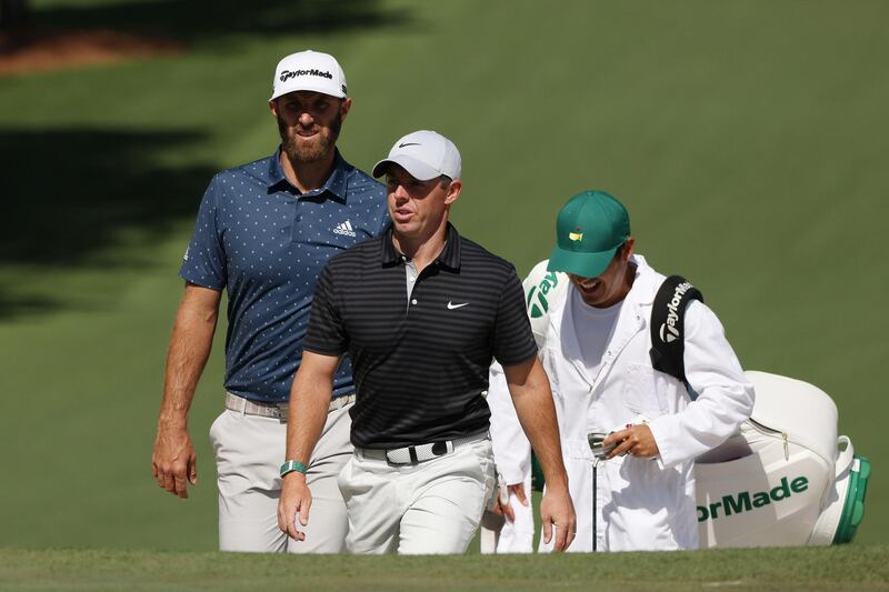 Dustin Johnson and Rory McIlroy walk on the seventh hole during a practice round prior to the Masters. AFP