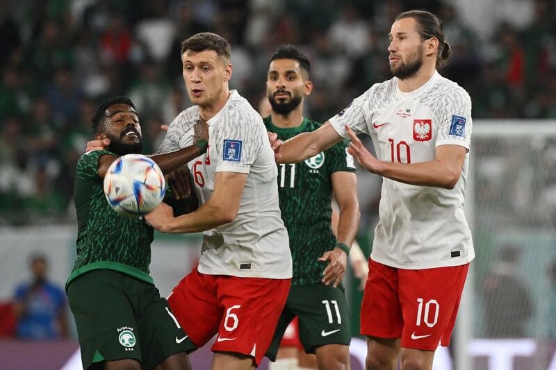 Saudi Arabia's midfielder Nawaf Al-Abed fights for the ball with Poland's Krystian Bielik. AFP