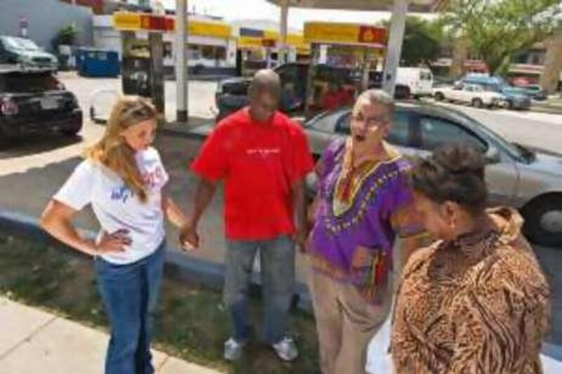 Pray At the Pump founder and leader Rocky Twyman(3rd from L) leads Angela Stevens(L) Kenneth Anderson(2nd L) and Jocelyne McClure(Rt) in prayer thanking God for lower prices for gasoline August 13, 2008 at a Shell station in Washington, DC. The group has been praying for lower prices for months as prices shot up and feel their prayers have been answered with the recent lower prices.   AFP Photo/Paul J. Richards