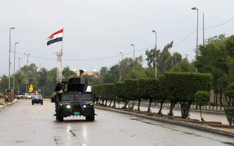 Iraqi security forces patrol a street, during a curfew imposed to prevent the spread of coronavirus disease (COVID-19), in Baghdad, Iraq March 18, 2020. REUTERS/Thaier Al-Sudani