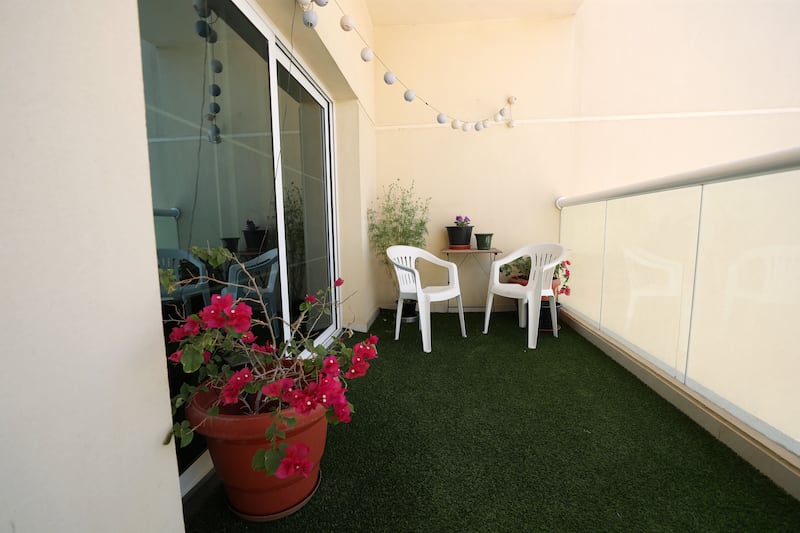 The balcony provides a relaxing space with some greenery 