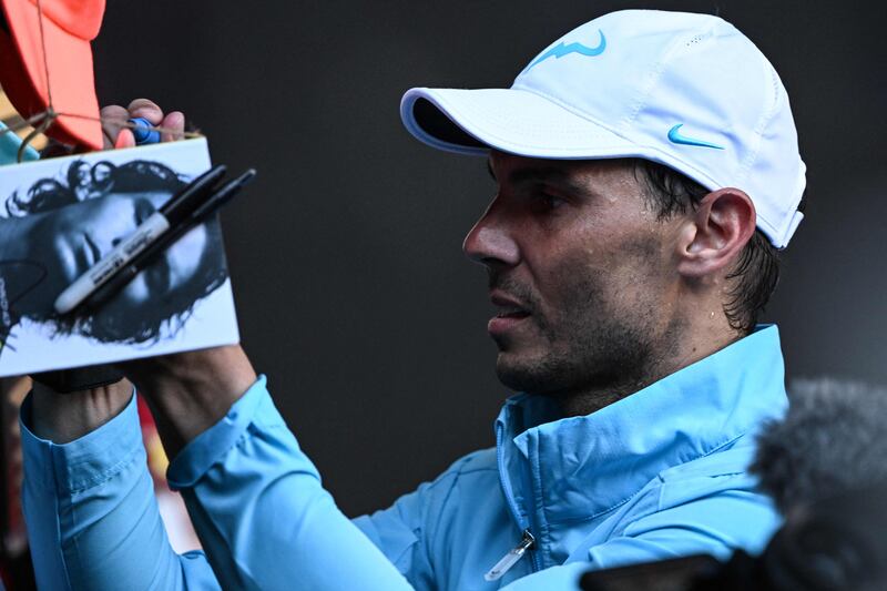 Rafael Nadal signs autographs after his victory over Jack Draper. AFP