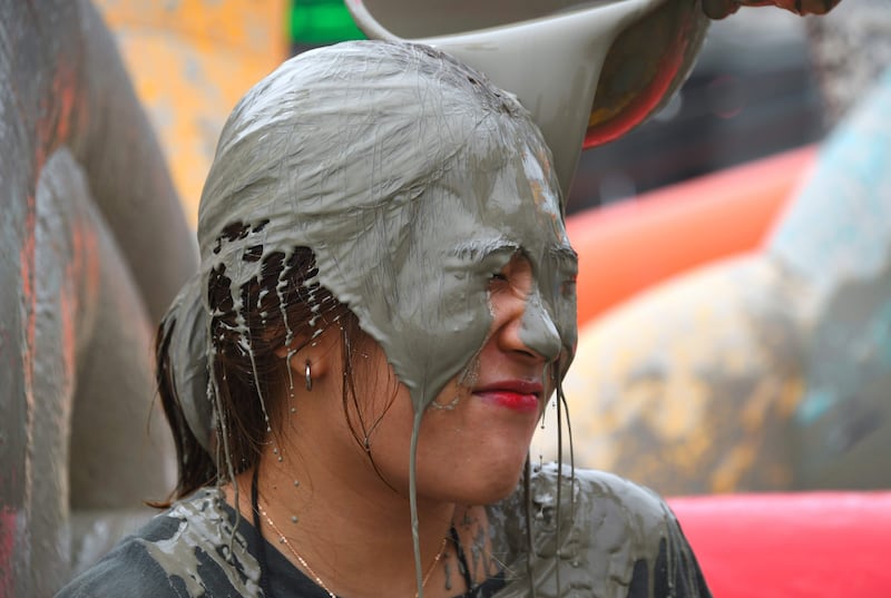 A woman is covered with mud during the festival at Daecheon beach in Boryeong. Jung Yeon-Je.
