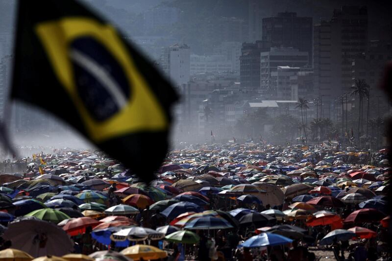 People spend time on Ipanema Beach, in Rio de Janeiro.  EPA