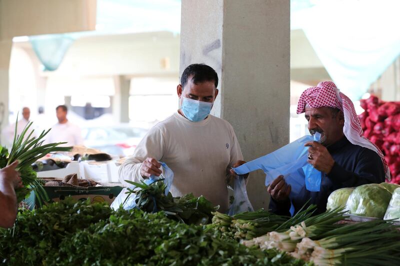A man wearing a protective face mask buys vegetables at a market, after Saudi Arabia imposed a temporary lockdown on the province of Qatif, following the spread of coronavirus, in Qatif, Saudi Arabia March 9, 2020. REUTERS/Stringer
