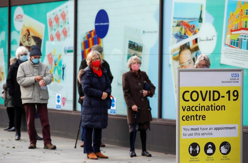 People queue to receive the coronavirus disease (COVID-19) vaccine outside a closed down Debenhams store that is being used as a vaccination centre in Folkestone, Kent, Britain January 28, 2021. REUTERS/Andrew Couldridge
