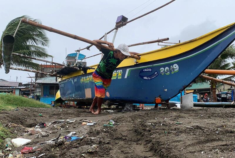Filipino villagers secure a fishing boat in anticipation of an approaching typhoon at a coastal village in Cavite City, Philippines.  EPA