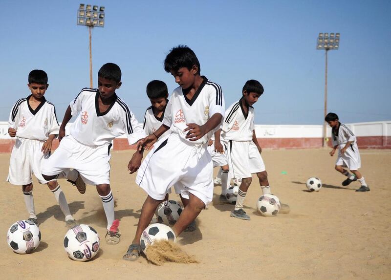 Pakistani youth participate in a training session at a local stadium in Karachi. On a dusty pitch in a Karachi slum, a group of scrawny Pakistani boys in the famous white shirt of Real Madrid tear around after a football as an academy backed by the Real Madrid Foundation, opened in March in one of the oldest parts of Pakistan’s sprawling, violent metropolis. Asif Hassan / AFP Photo