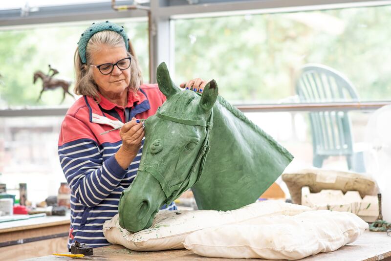 Ms Wallace works on the head of Burmese - Queen Elizabeth's favourite ceremonial steed. Photo: Miranda Meiklejohn