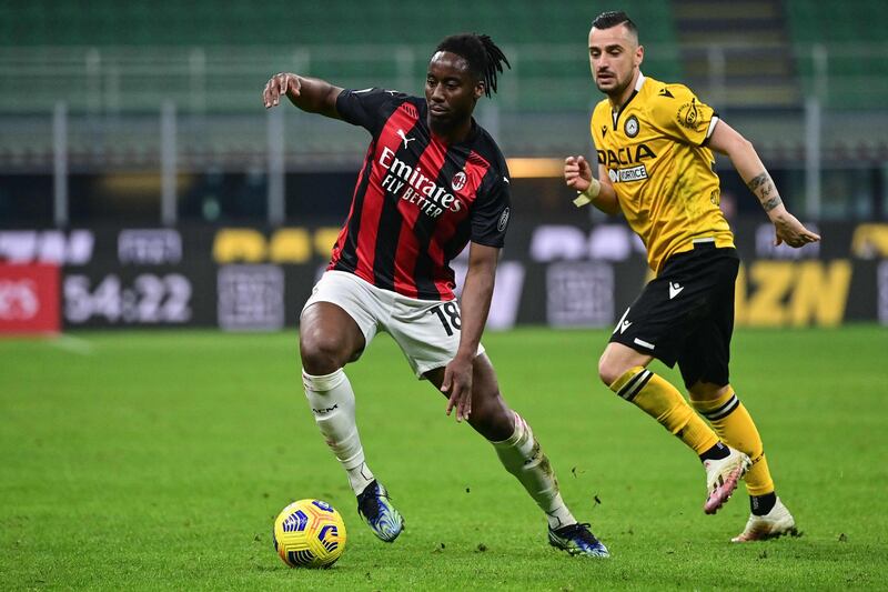 AC Milan's French midfielder Souhaliho Meite outruns Udinese's Brazilian defender Samir. AFP