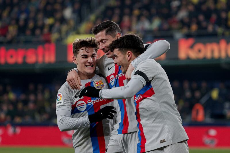 Pedri celebrates with Robert Lewandowski and Gavi after scoring for Barcelona against Villarreal. EPA