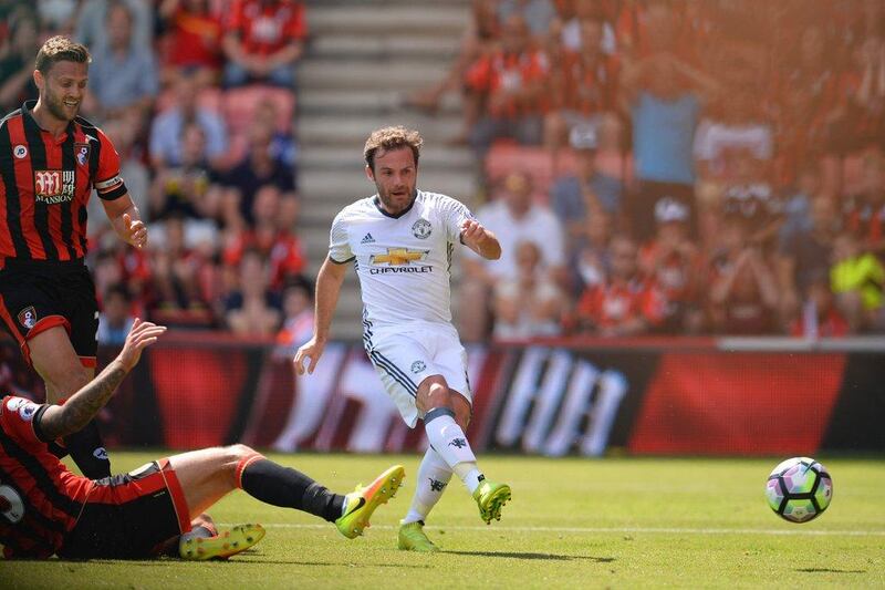 Manchester United midfielder Juan Mata (R) scores the opening goal during the Premier League football match between Bournemouth and Manchester United at the Vitality Stadium in Bournemouth, southern England on August 14, 2016. Glyn Kirk / AFP