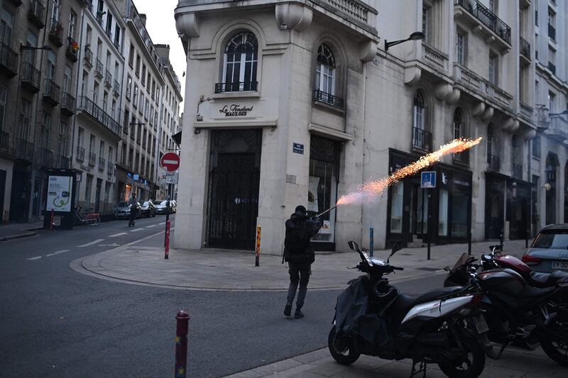 In Nantes, a demonstrator shoots fireworks towards police. AFP